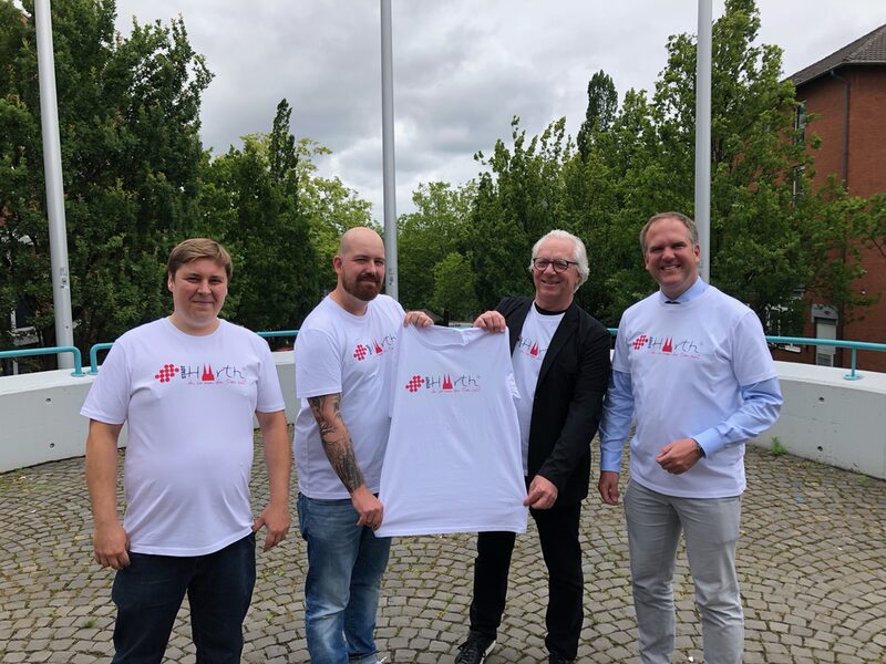 Foto v.l. Tobias Pook, CTO von Shirtigo, Tim Schneider, CMO & Co-Founder von Shirtigo, Rüdiger Winkler, Vorsitzender des Partnerschaftsvereins, Dirk Breuer, Bürgermeister.